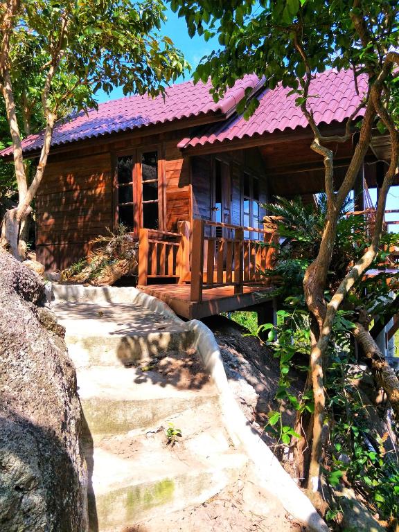 a wooden house with a staircase leading to it at Moondance Magic View Bungalow in Ko Tao