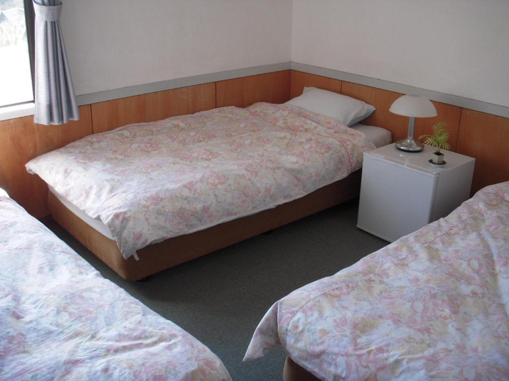 Postel nebo postele na pokoji v ubytování Guest House Ishitatu