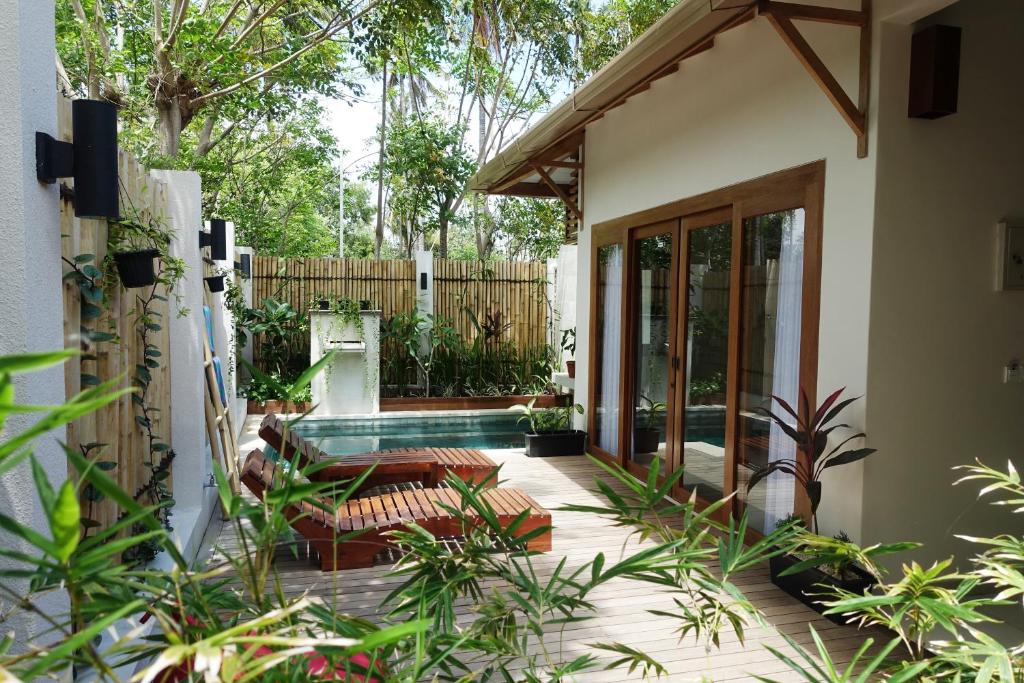 a backyard with a swimming pool and a house at Ke Rensia Private Pool Villas Gili Air in Gili Islands