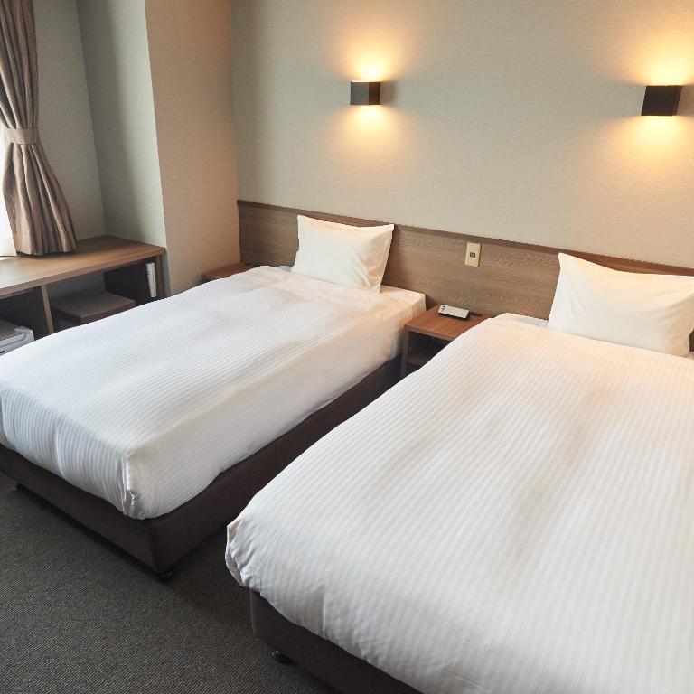 Postel nebo postele na pokoji v ubytování Conne Hotel