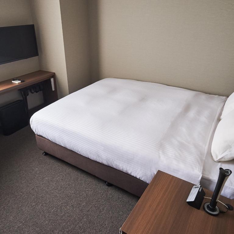 Postel nebo postele na pokoji v ubytování Conne Hotel