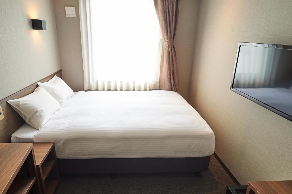 Postel nebo postele na pokoji v ubytování Conne Hotel