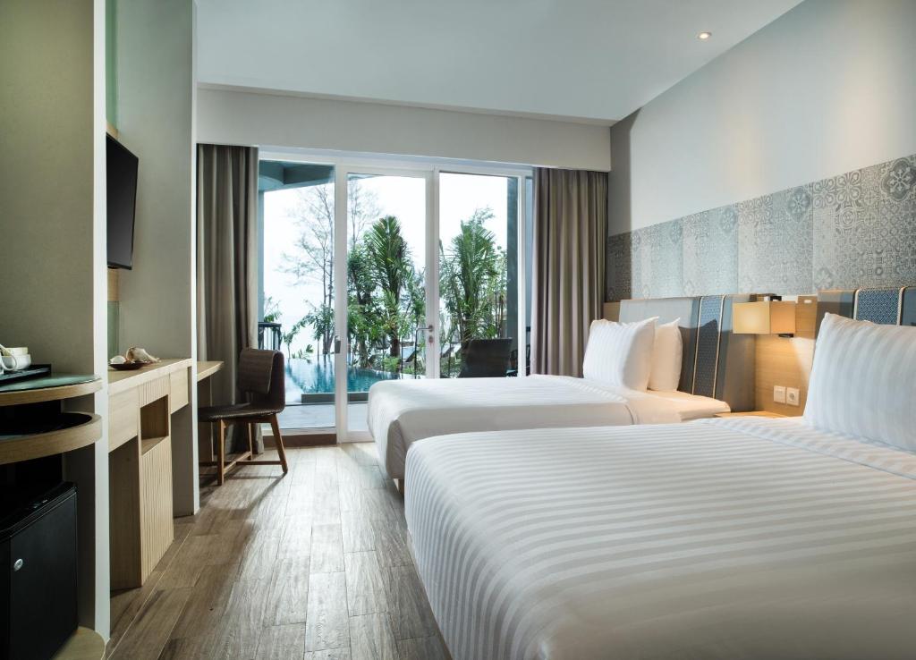 Postel nebo postele na pokoji v ubytování Hotel Santika Premiere Beach Resort Belitung