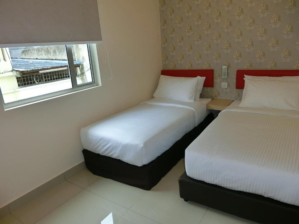 Postel nebo postele na pokoji v ubytování Carlsun Hotel