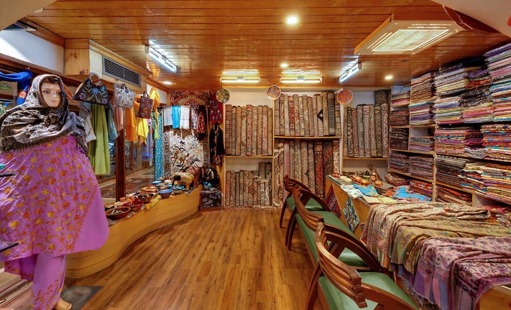a woman standing in a room with a store at Welcomhotel by ITC Hotels, Pine N Peak, Pahalgam in Pahalgām