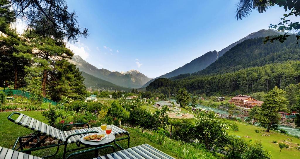 a table with a plate of food on top of a field at Welcomhotel by ITC Hotels, Pine N Peak, Pahalgam in Pahalgām
