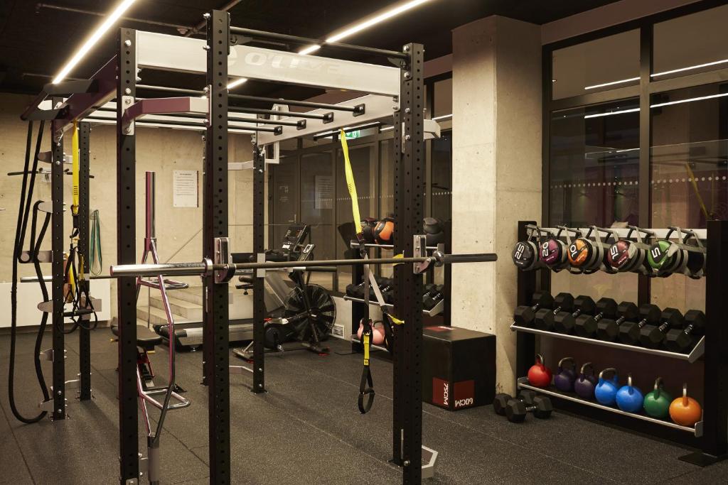 a gym with a lot of equipment in it at Steel House Copenhagen in Copenhagen