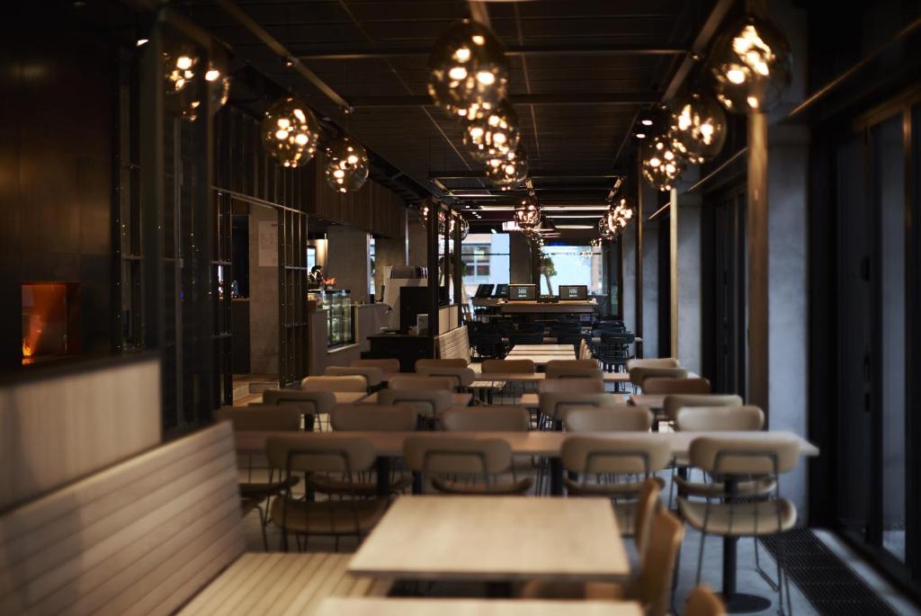 a row of tables and chairs in a restaurant at Steel House Copenhagen in Copenhagen