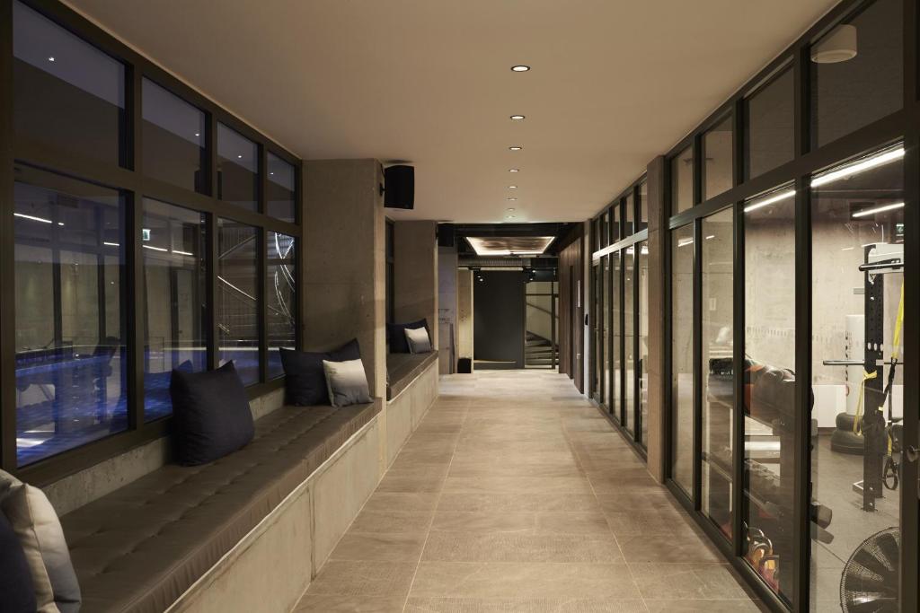 a hallway of a building with windows and a hallway at Steel House Copenhagen in Copenhagen