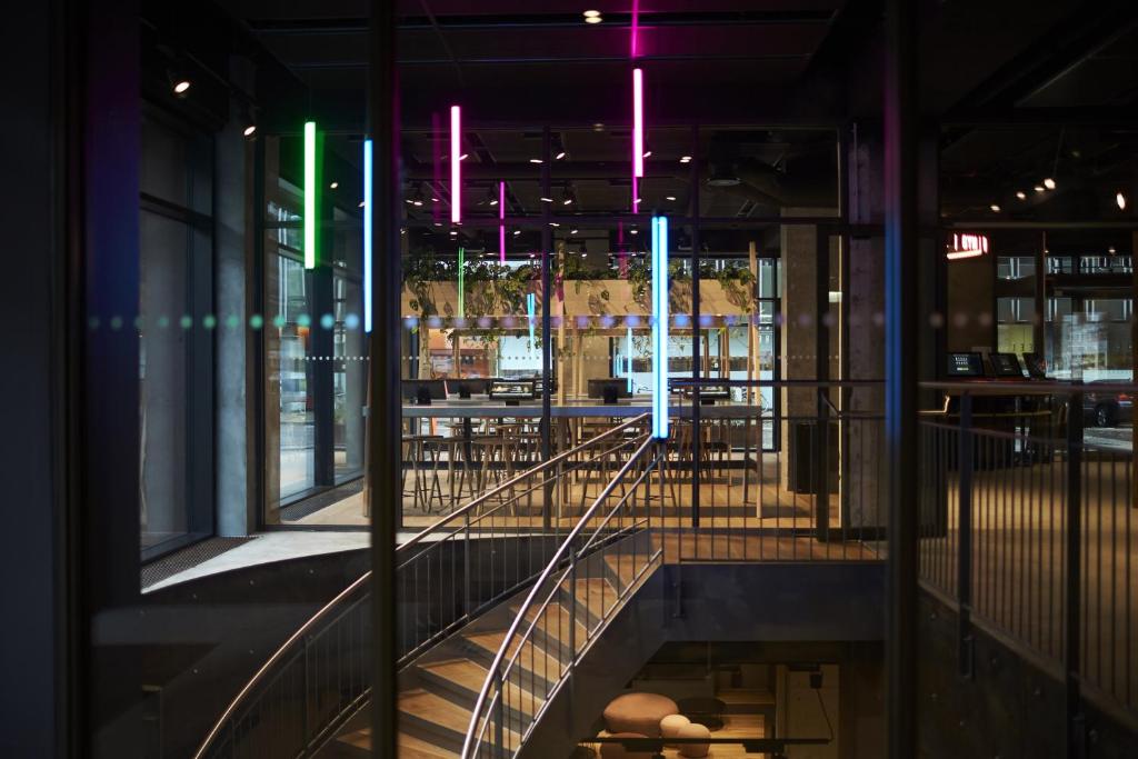 a staircase in a building with lights on the ceiling at Steel House Copenhagen in Copenhagen