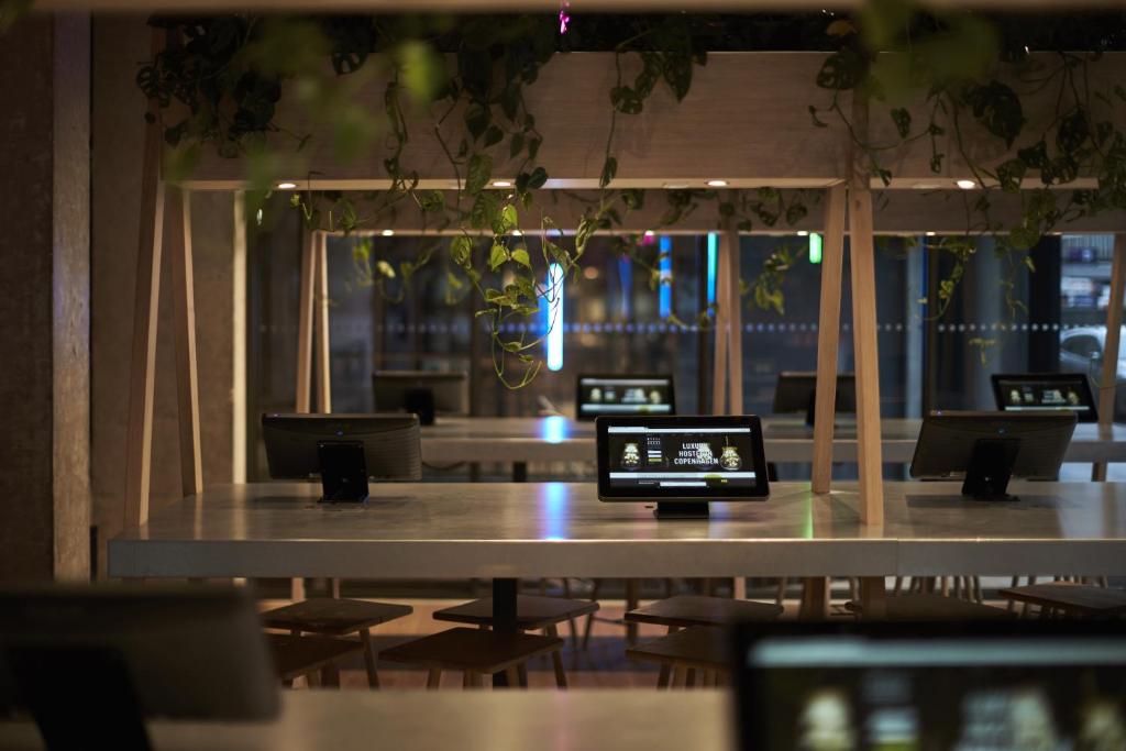 a table with chairs and a laptop on top of it at Steel House Copenhagen in Copenhagen
