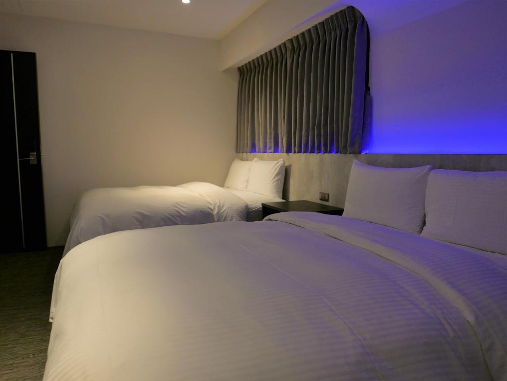 泊居旅店二館 Oursinn Hotel 2にあるベッド