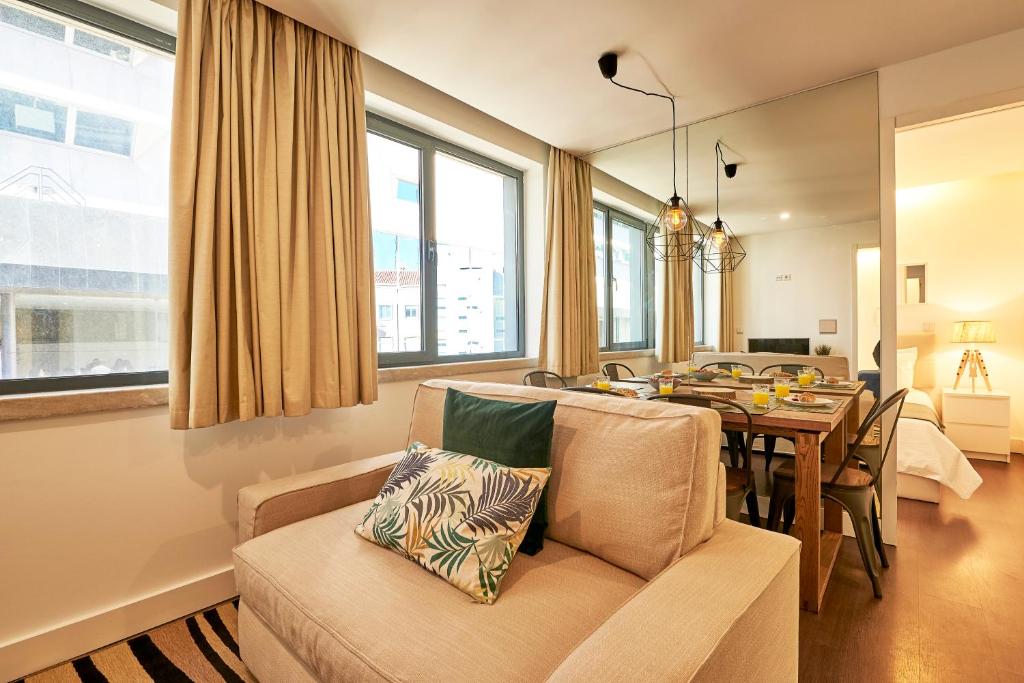 a living room with a couch and a table at Modern Apartment Marquês in Lisbon