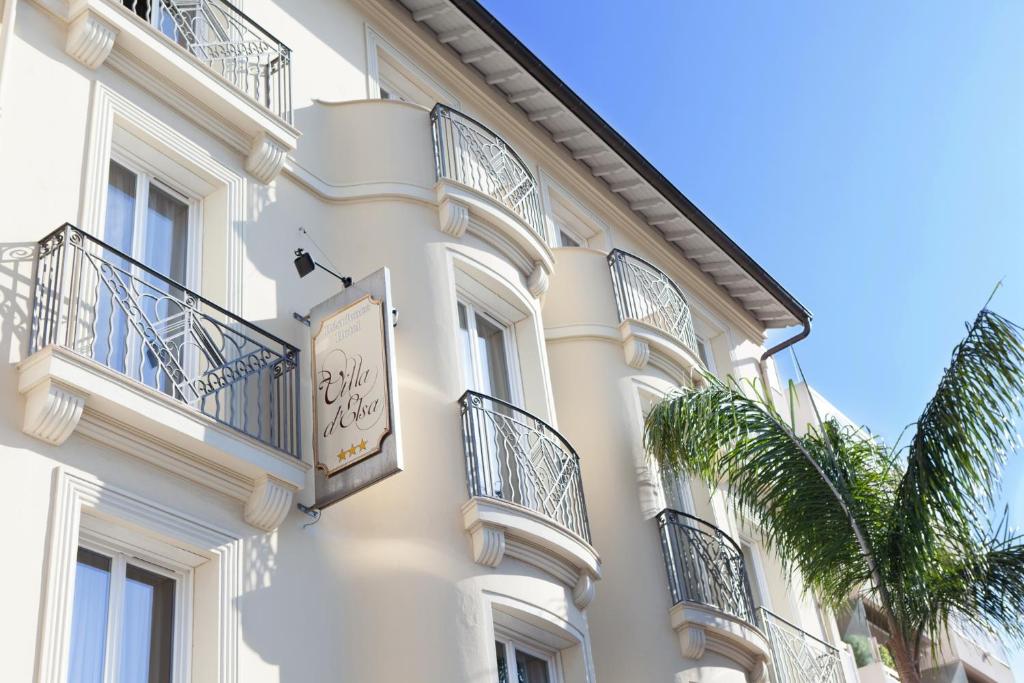 a building with a clock on the side of it at Hotel Villa d'Elsa in Juan-les-Pins