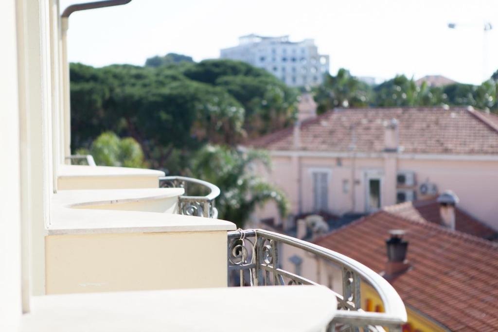 a balcony with a view of a city at Hotel Villa d'Elsa in Juan-les-Pins