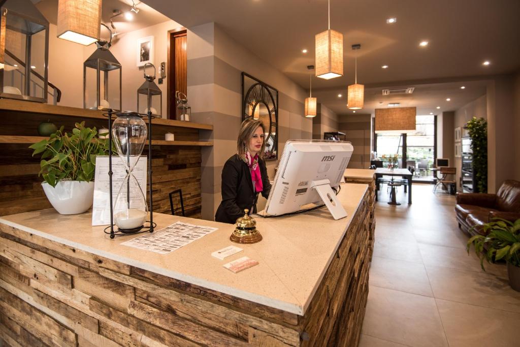 a woman standing at a counter in a store at Hotel Orcagna in Florence