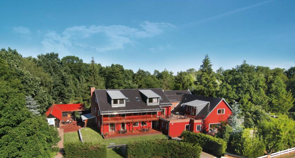 an aerial view of a large red house in the forest at WassermannApartments in Burg