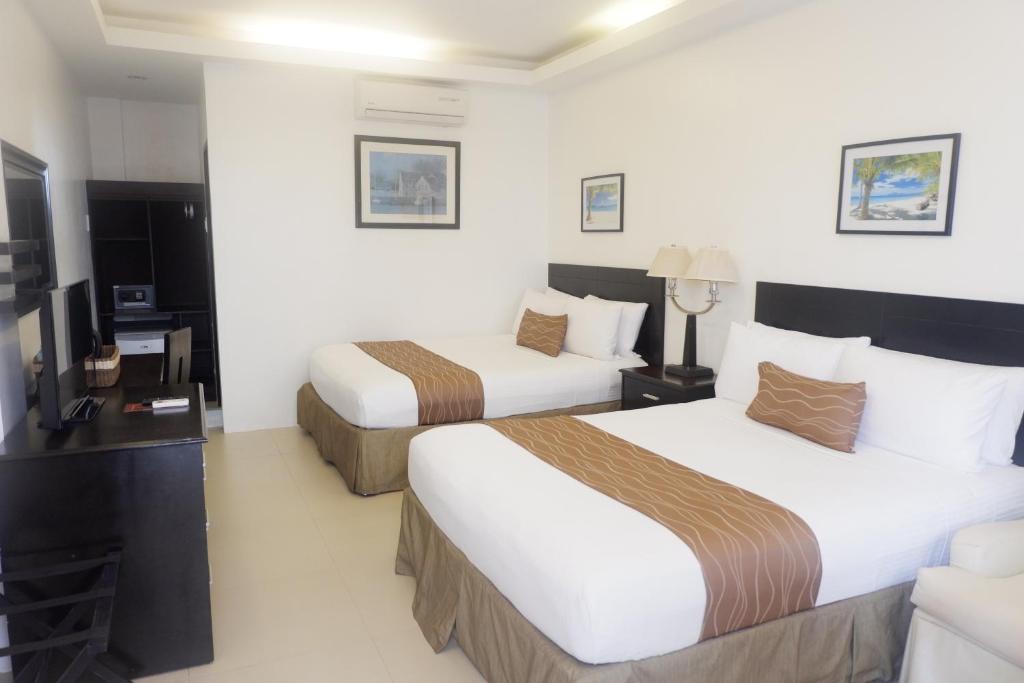 Postel nebo postele na pokoji v ubytování Chateau De Boracay