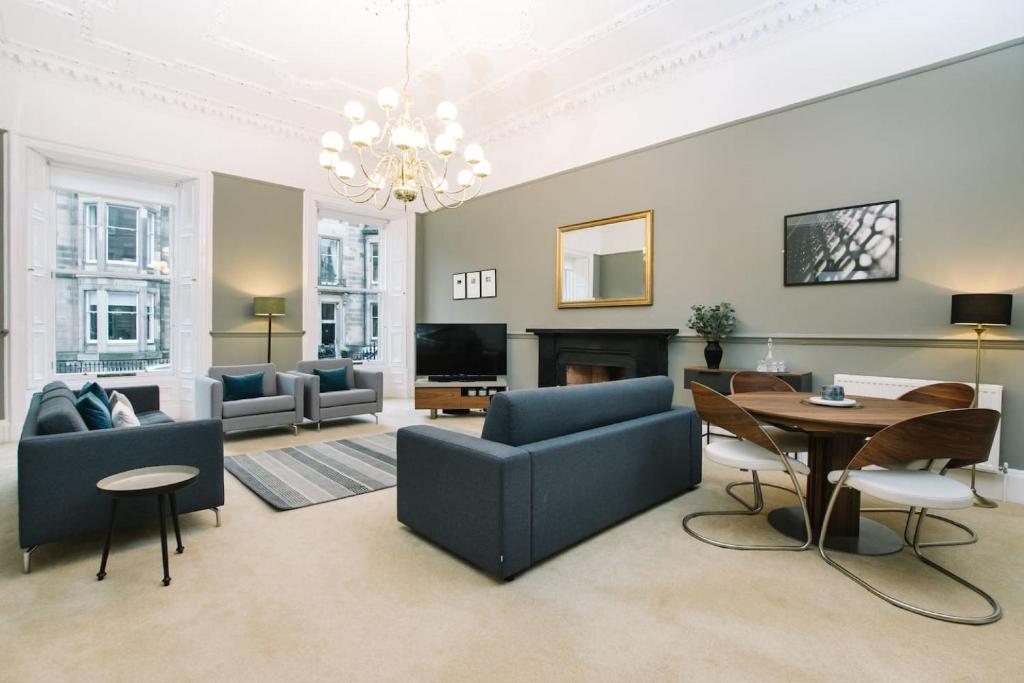 a living room with a couch and a table at ALTIDO Palmerston Place Residence - Luxury City Centre Apt with Private Parking in Edinburgh