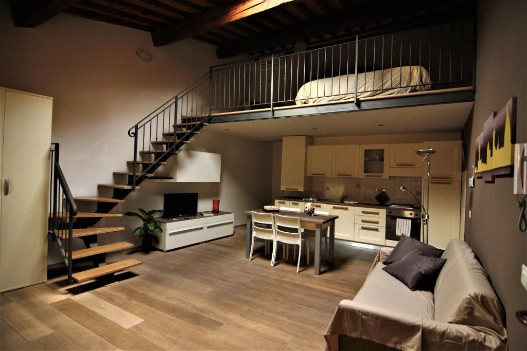 a living room with a couch and a loft at Sweet Home In Santa Croce in Florence