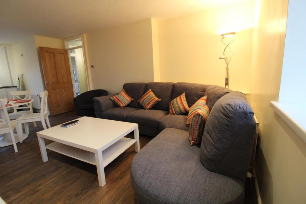 a living room with a couch and a table at Maryville Apartment by Townlets in Belfast
