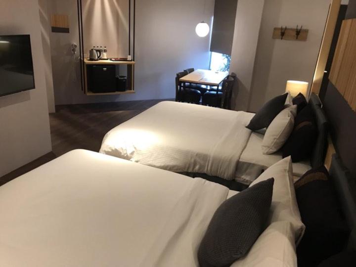 Postel nebo postele na pokoji v ubytování Roppongi Motel - Dalian
