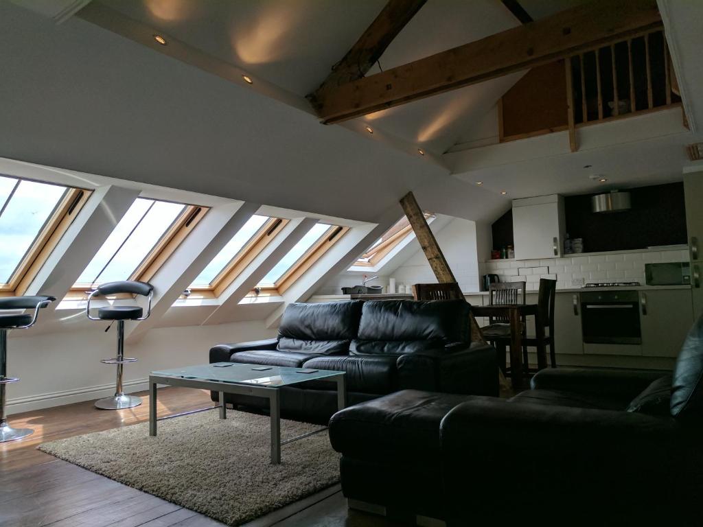 a living room with two couches and a table at Northcliffe Sea View in Sunderland