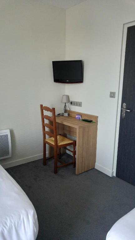 Postel nebo postele na pokoji v ubytování Hôtel Le Verger