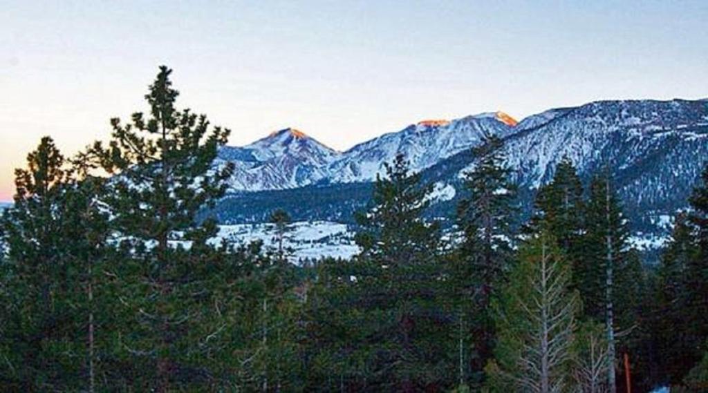 a view of a mountain range with snow covered mountains at Mammoth Point by 101 Great Escapes in Mammoth Lakes