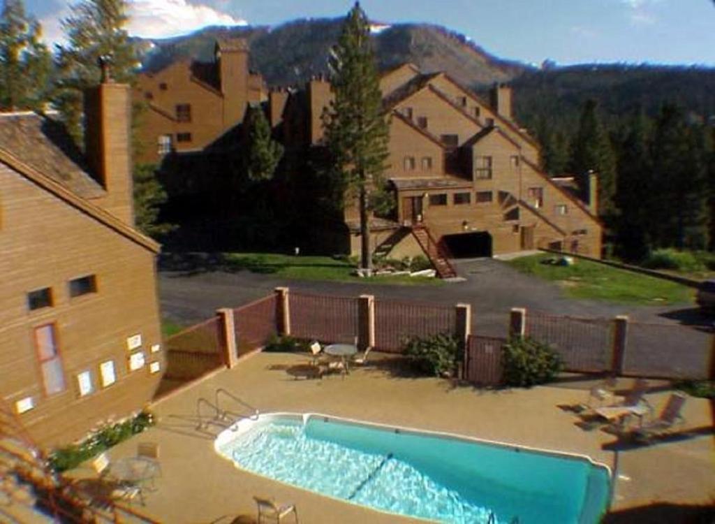a swimming pool in a yard next to a house at Aspen Creek by 101 Great Escapes in Mammoth Lakes