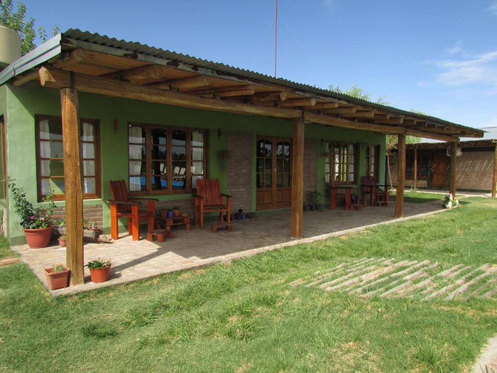 a house with a patio with a table and chairs at Cabañas Las Bahienses in San Rafael