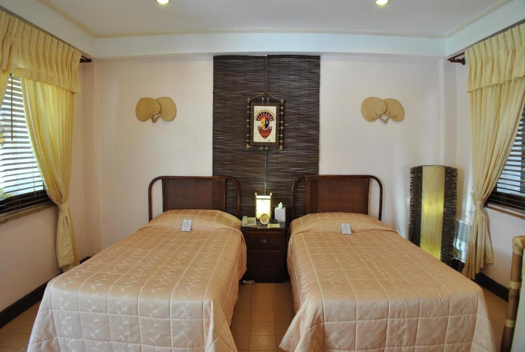 Postel nebo postele na pokoji v ubytování Surfside Boracay Resort