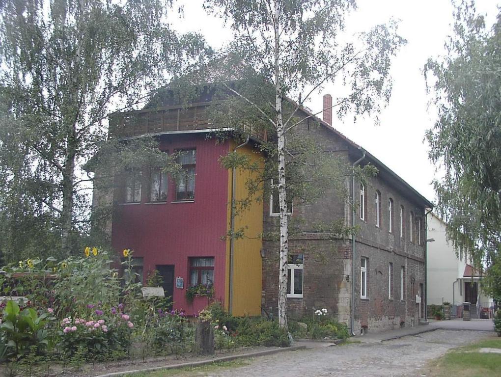 a red and yellow building on a street at Hostel Falkenstein in Falkenstein