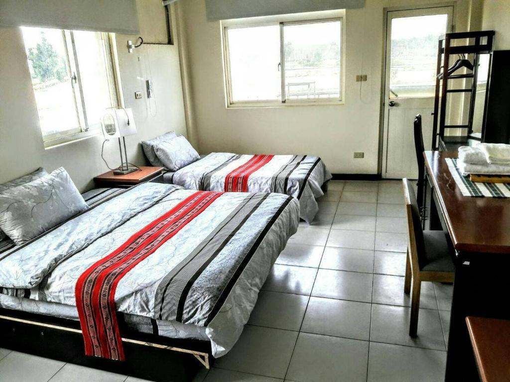 Postel nebo postele na pokoji v ubytování Hsianghua Guesthouse
