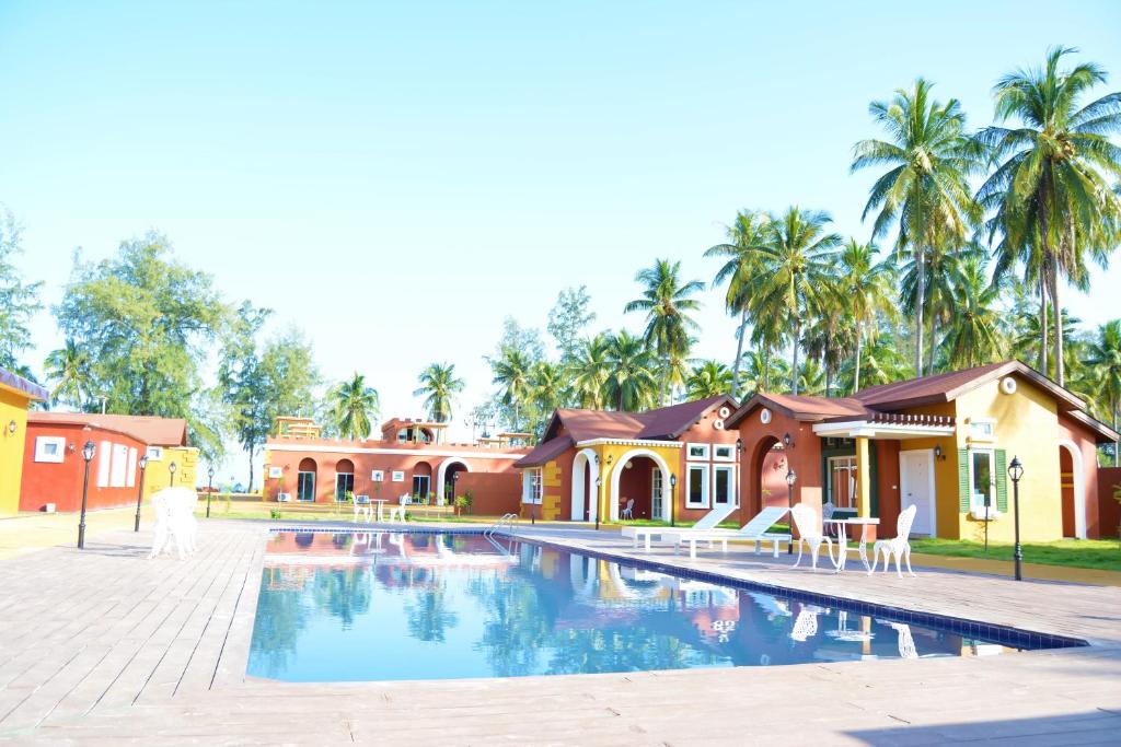 a beach with a pool and a swimming pool at World Cat Resort in Bang Saphan