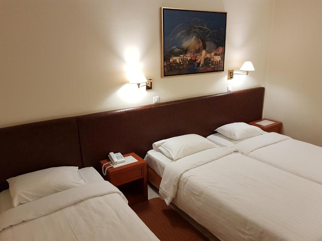 Postel nebo postele na pokoji v ubytování Liberty Hotel
