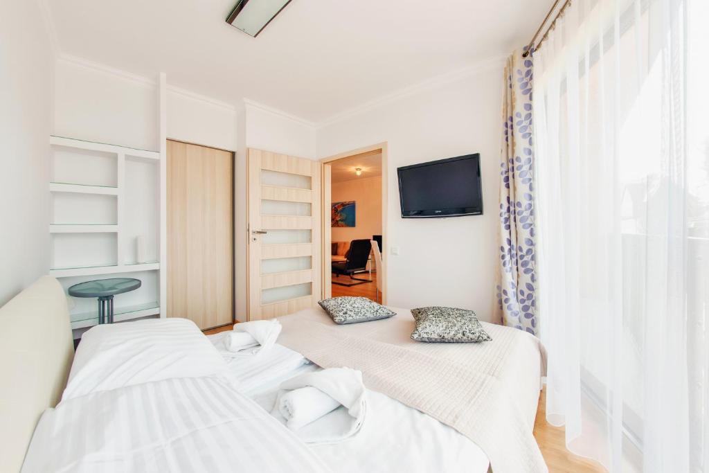 Posteľ alebo postele v izbe v ubytovaní Apartamenty Sun & Snow Horyzont