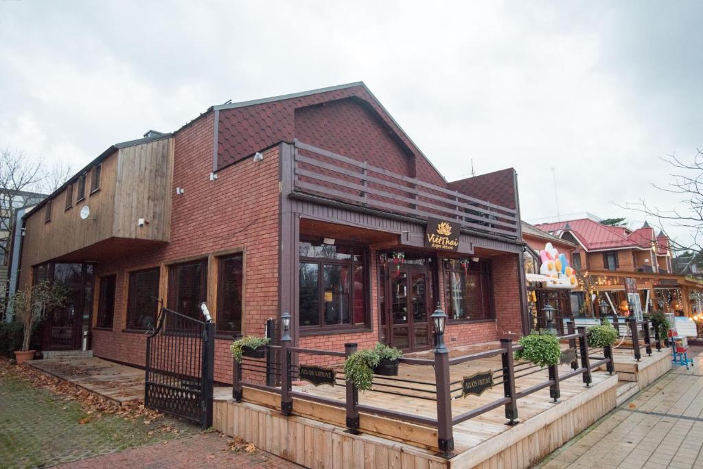 a store front of a brick building on a street at Guest House Lotus in Palanga