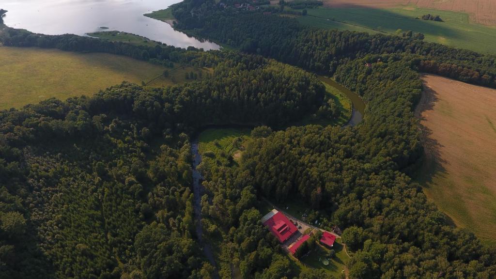 an aerial view of a house in the middle of a forest at Ośrodek leśny Rajsko w Zapuście in Zapusta