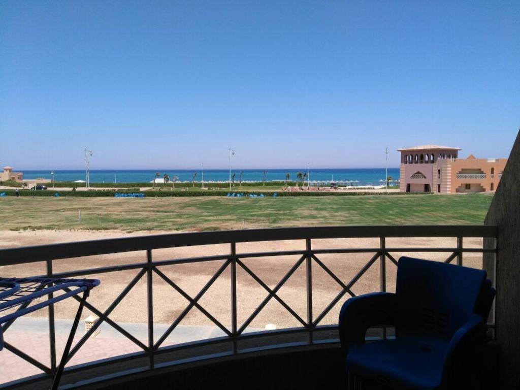 a view of the beach from a balcony with a chair at one bedroom Chalet at Porto South Beach Royal Sea View Families only in Ain Sokhna
