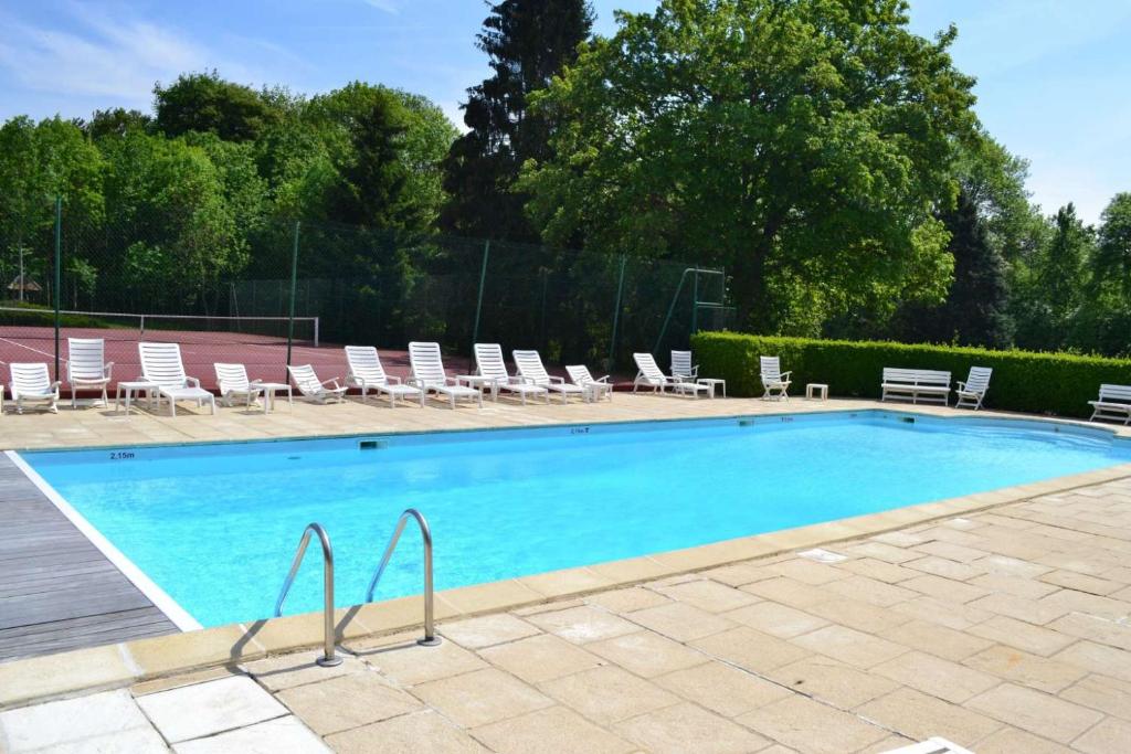 a swimming pool with chairs and a bunch at Château du Landel, The Originals Relais (Relais du Silence) in Bézancourt