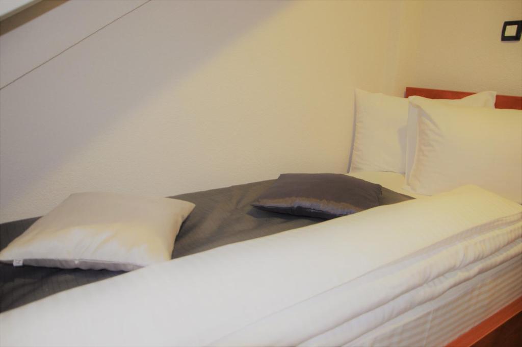 Postel nebo postele na pokoji v ubytování Hotel Noble