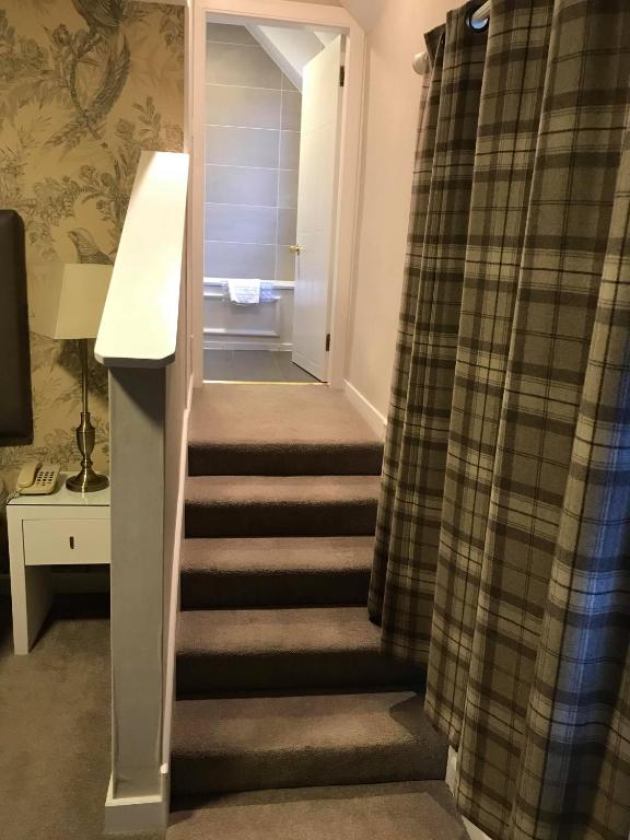 a stairway leading to a room with a stair case at Bridge of Orchy Hotel in Bridge of Orchy
