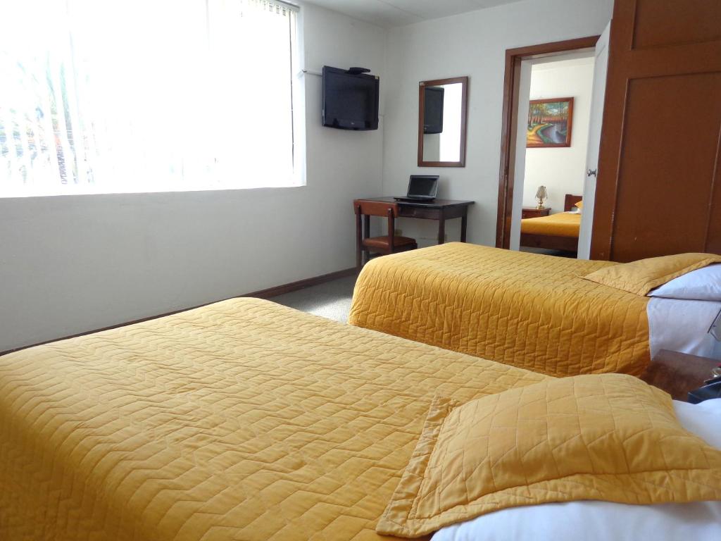 Postel nebo postele na pokoji v ubytování Hotel 9 de Octubre