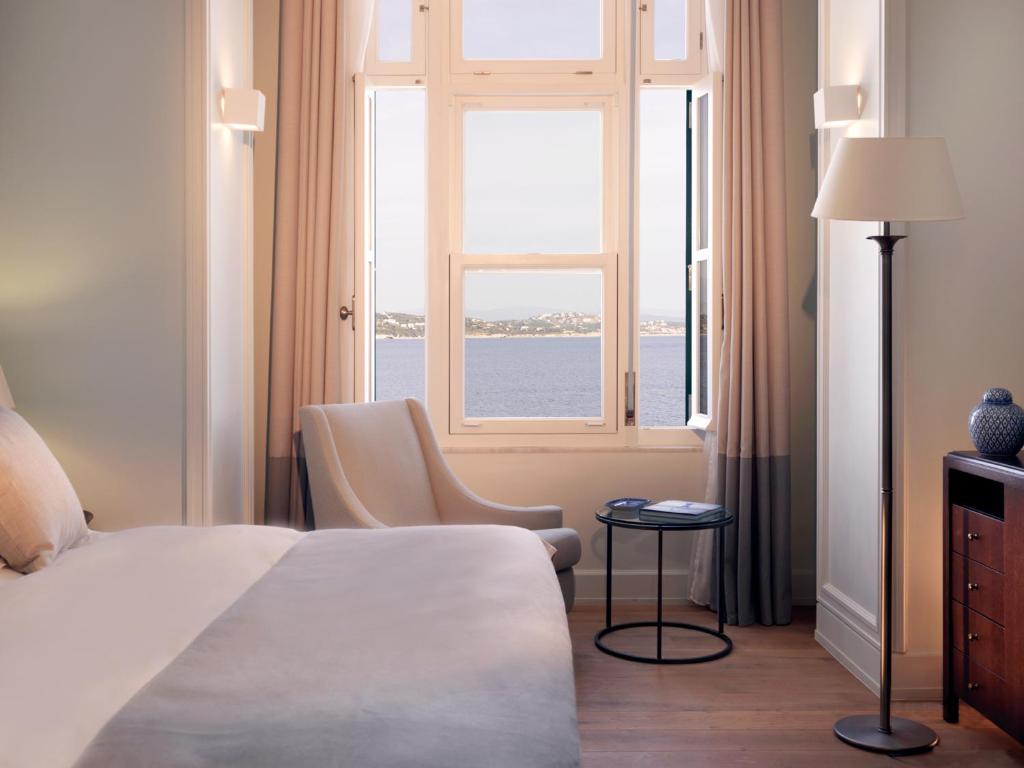 a hotel room with a bed and a window at Poseidonion Grand Hotel in Spetses