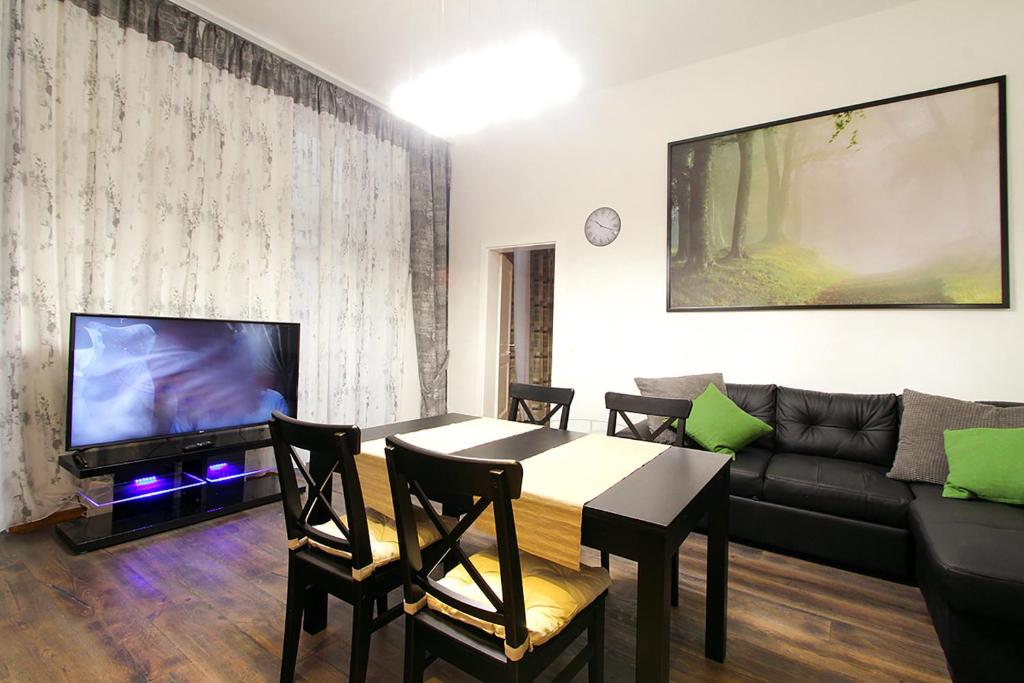 a living room with a table and a couch at Lana Appartements in Vienna