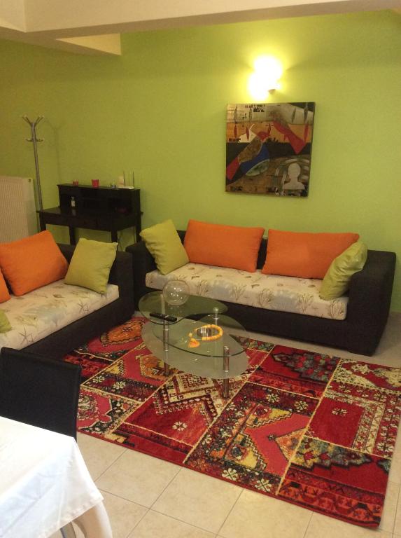 a living room with two couches and a rug at Modern Basement Apartment Gio Ii in Zakynthos Town