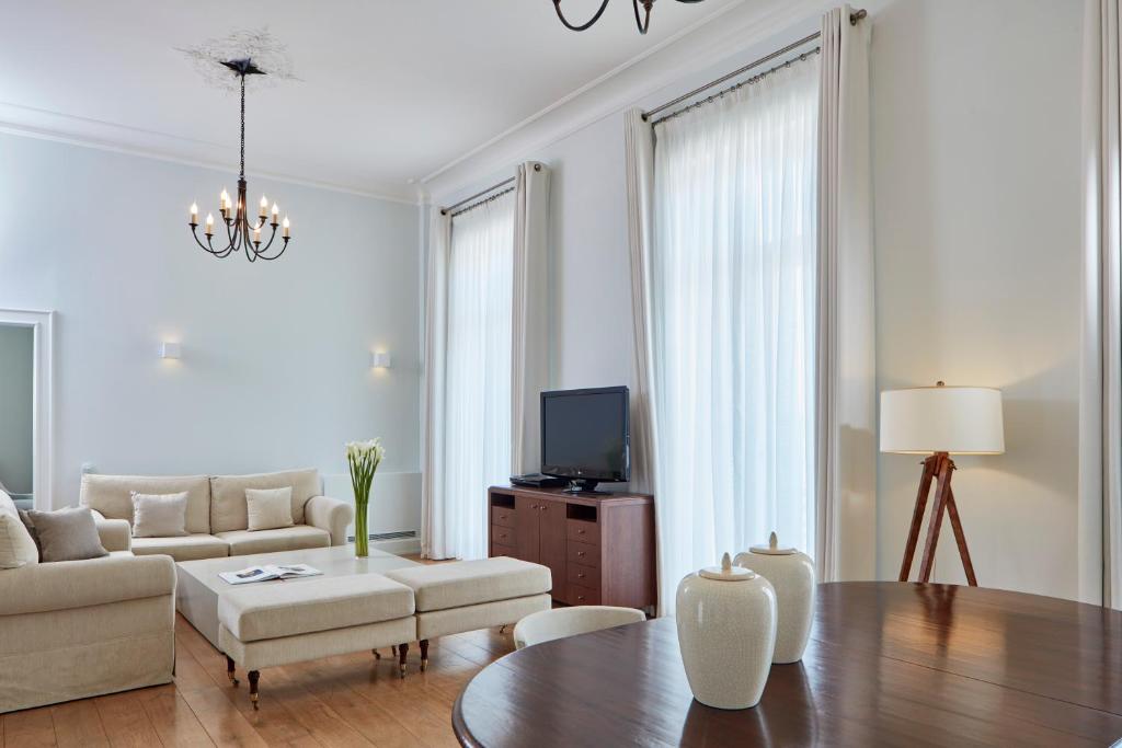 a living room with a couch and a table at Poseidonion Grand Hotel in Spetses