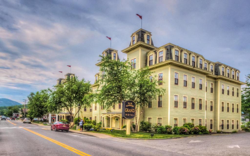 a large building with a clock on the side of it at Bar Harbor Grand Hotel in Bar Harbor