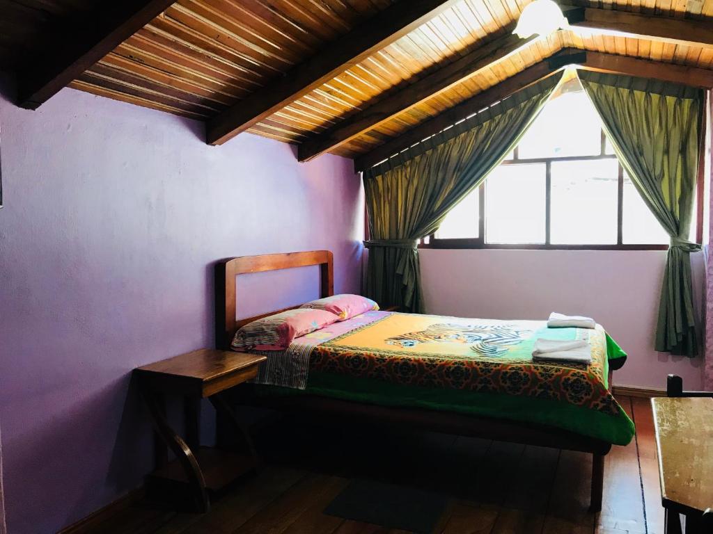 Postel nebo postele na pokoji v ubytování Hostal Princesa Maria